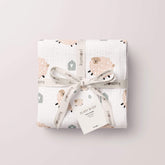 Fluffy sheep swaddle neatly folded and tied with ribbon